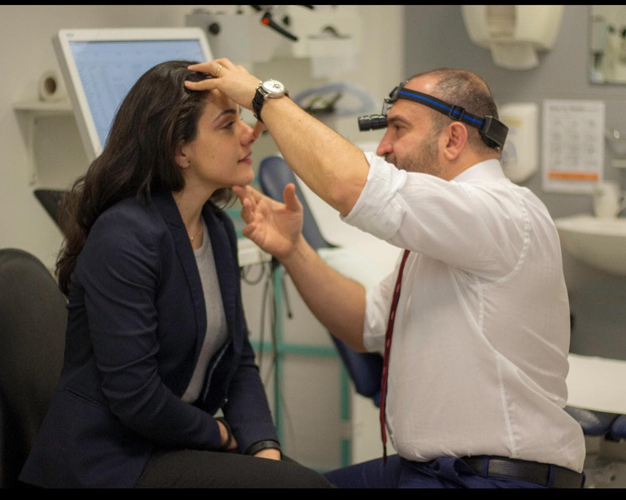 Mr Anwar examining a patient during an ENT consultation