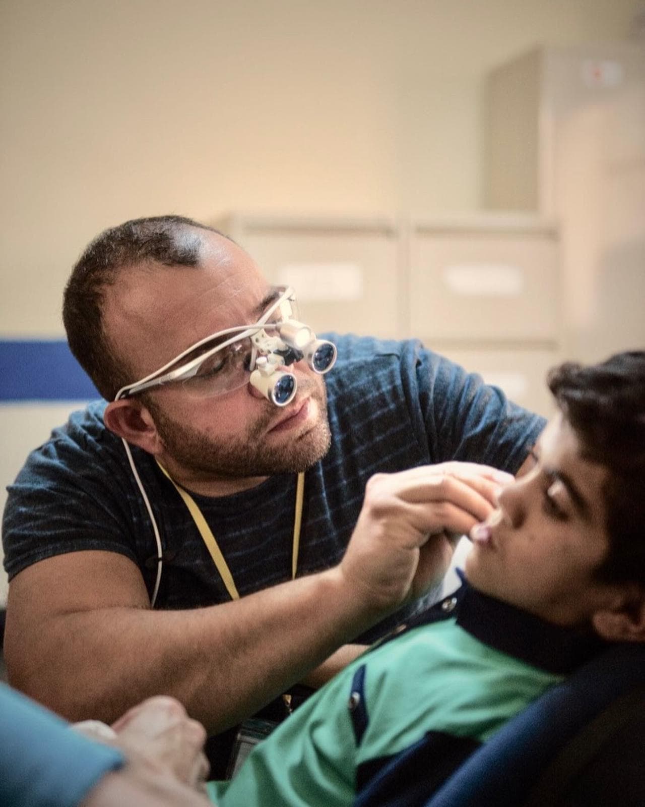 Mr Anwar assessing a young patient during humanitarian work