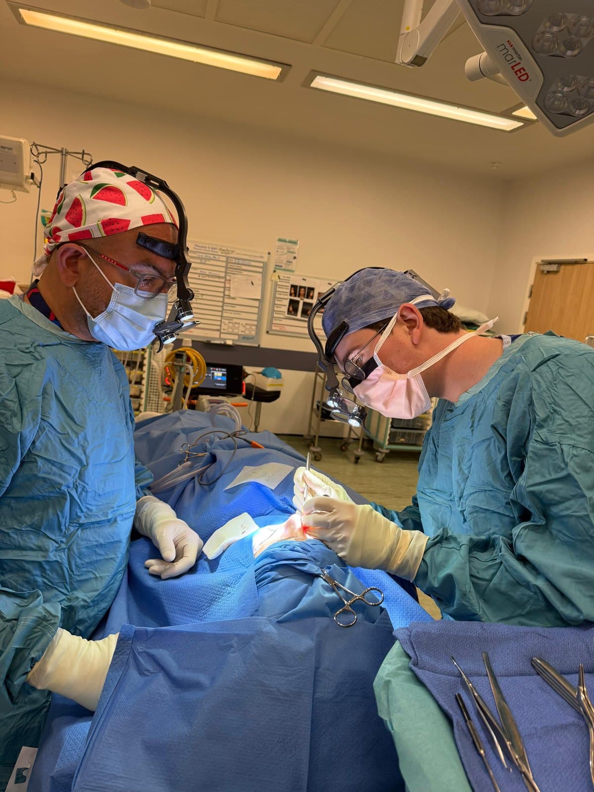 Mr Anwar operating in theatre with a colleague